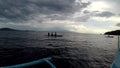 Boat outriggers moving through ocean waves